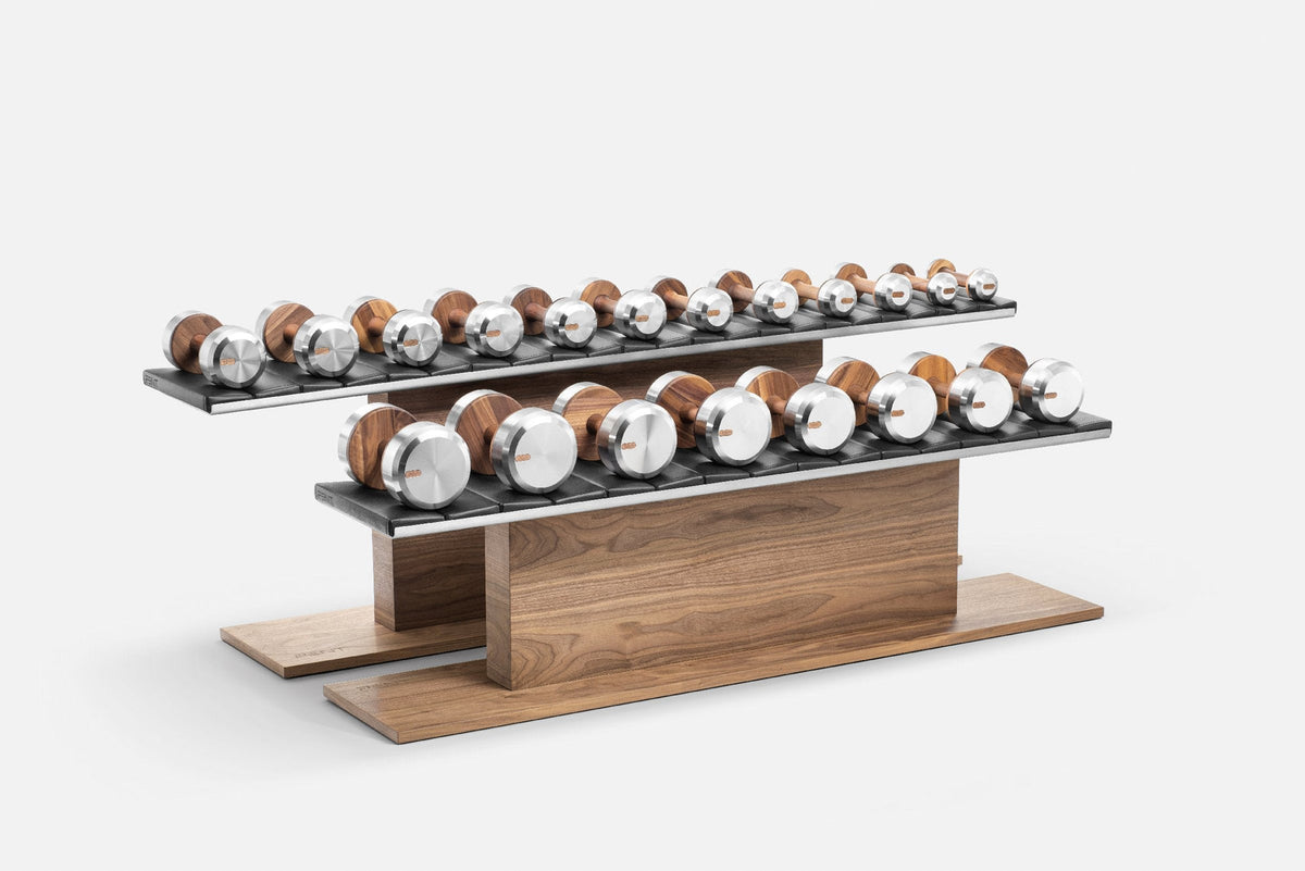 Two-tier rack of dumbbells with silver end caps and wood-grain handles on dark padded trays