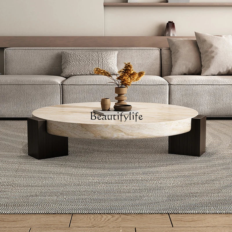Travertine-finish coffee table in a living room setting, angled view showing the tabletop and base