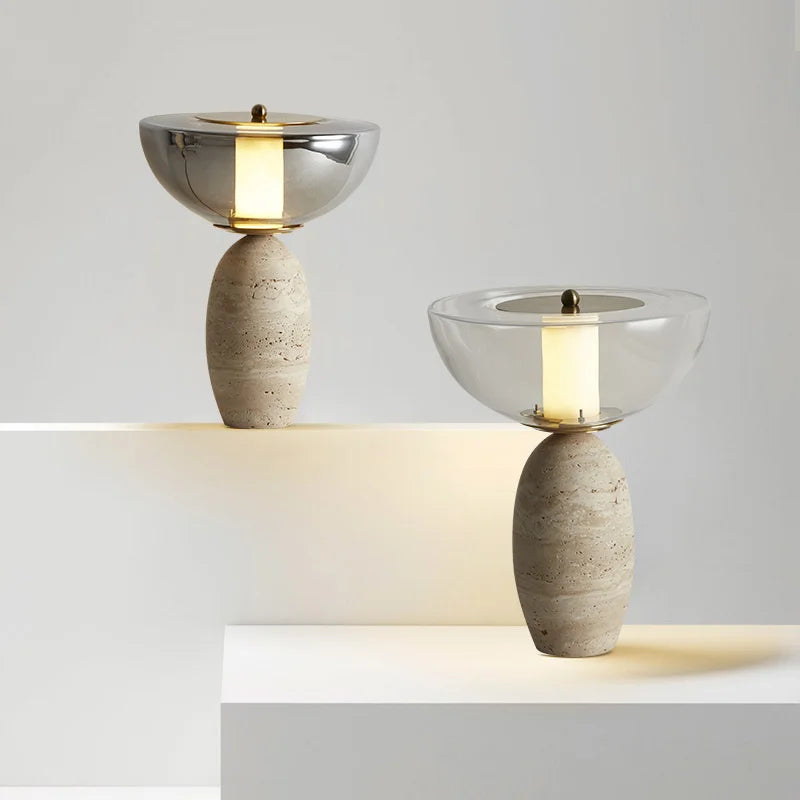 Two table lamps with bowl-shaped shades and speckled stone bases on white platforms
