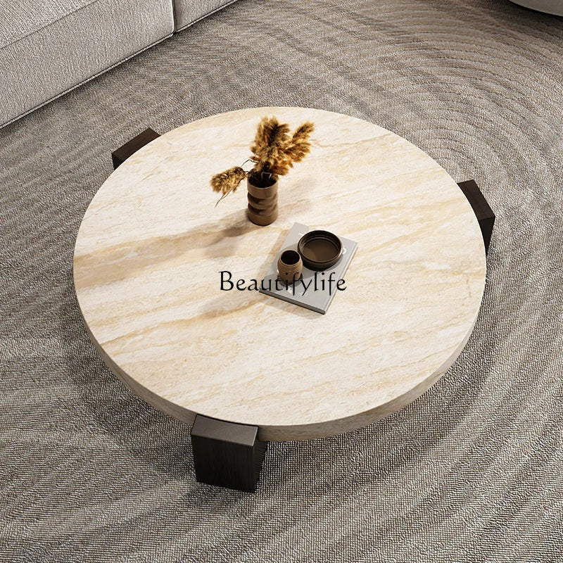 Overhead view of the round travertine-finish coffee table showing the stone-look tabletop surface