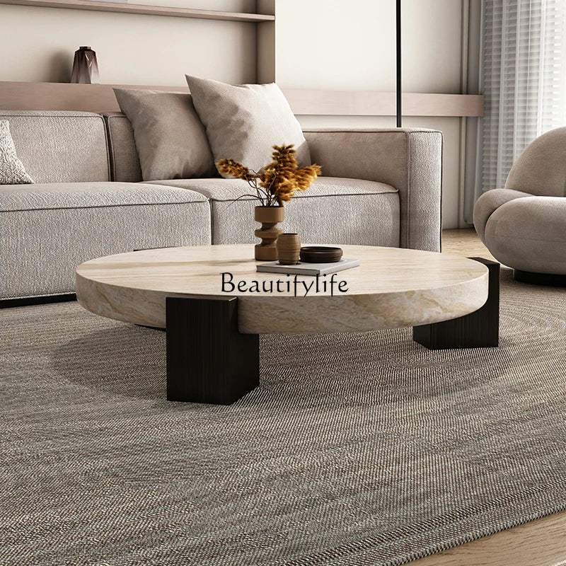 Travertine-finish coffee table styled in a sophisticated living room with sofa and armchair