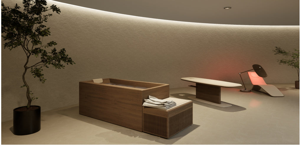 Dim spa room with a wood-grain tub, slatted bench with towels and a chair with lit backrest