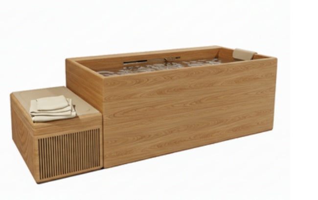 Open-top wooden tub with water and fittings beside a slatted box topped with folded towels